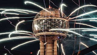 Street photography of dallas architecture with fireworks exploding in background