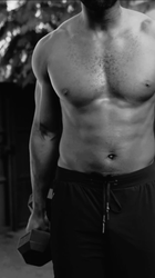 a man 's torso is shown in a black and white photo