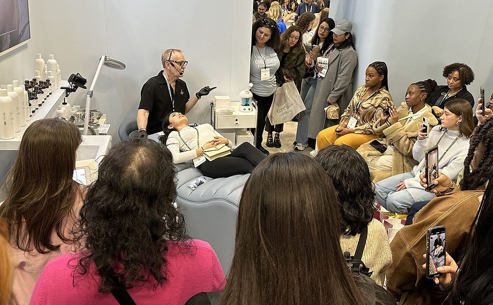 Estheticians and skincare professionals walking through a beauty industry trade show