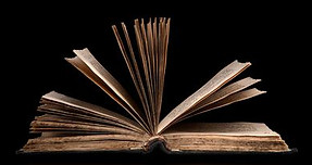 84876236-an-open-bible-on-a-black-backgr