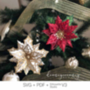 DIY paper Christmas poinsettia ornament assembled from digital template, displayed as festive holiday decoration.