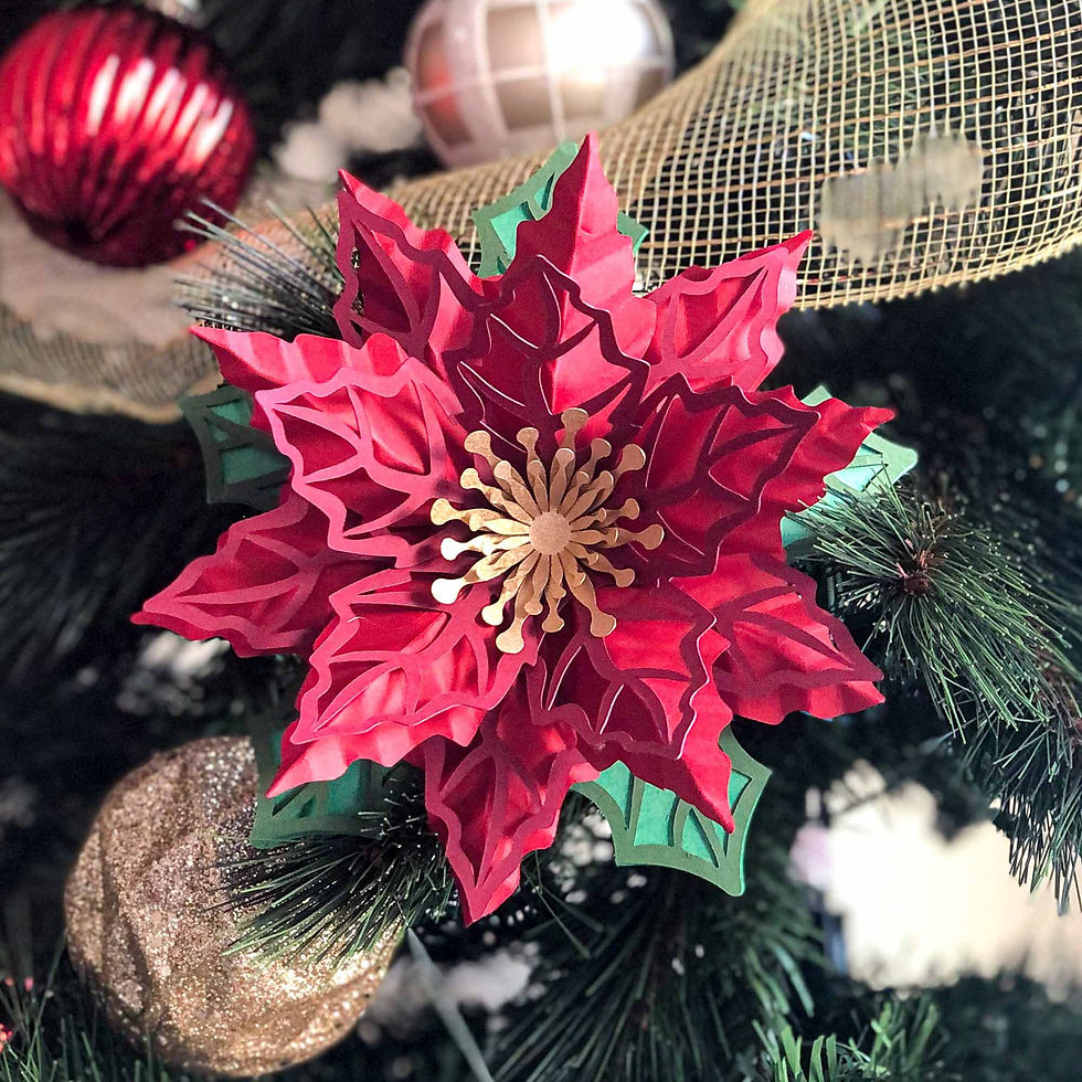 DIY paper Christmas poinsettia ornament assembled from digital template, displayed as festive holiday decoration.