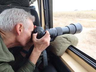 Wildlife photographer takes photographs in Amboseli during a kenya photo safari