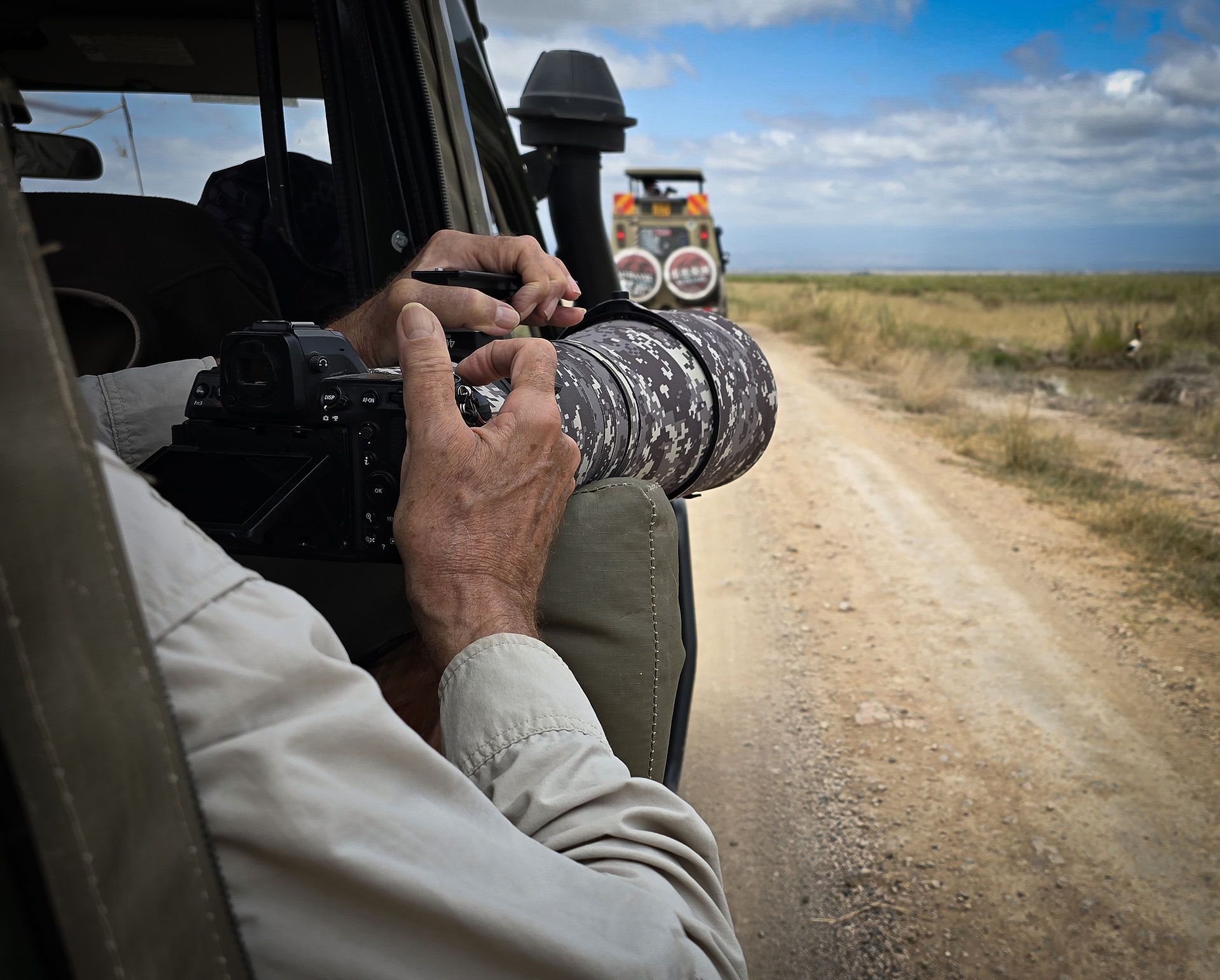 A private guest takes photographs of Amboseli elephants during a private photo safari