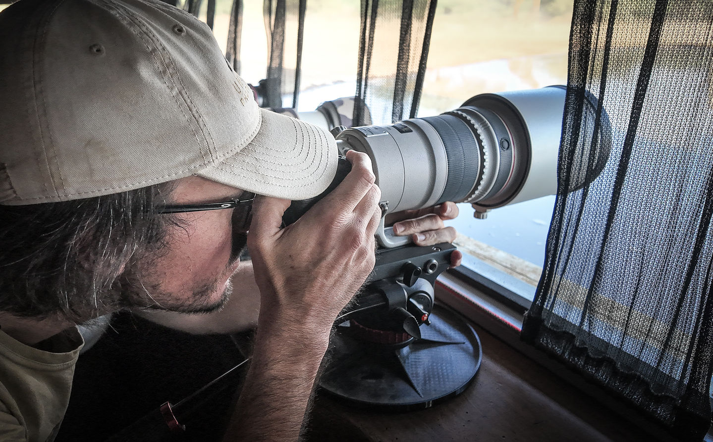 British wildlife photographer Mark A Fernley photographing wildlife from Shompole Hide here in Kenya