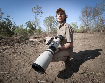 Professional and award winning Wildlife Photographer Mark A Fernley waits for lions to come to a waterhole here in Botswana with his Canon telephoto lens - Mark Fernley Wildlife.