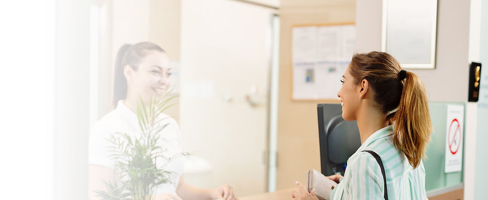 A patient checking out at the front desk