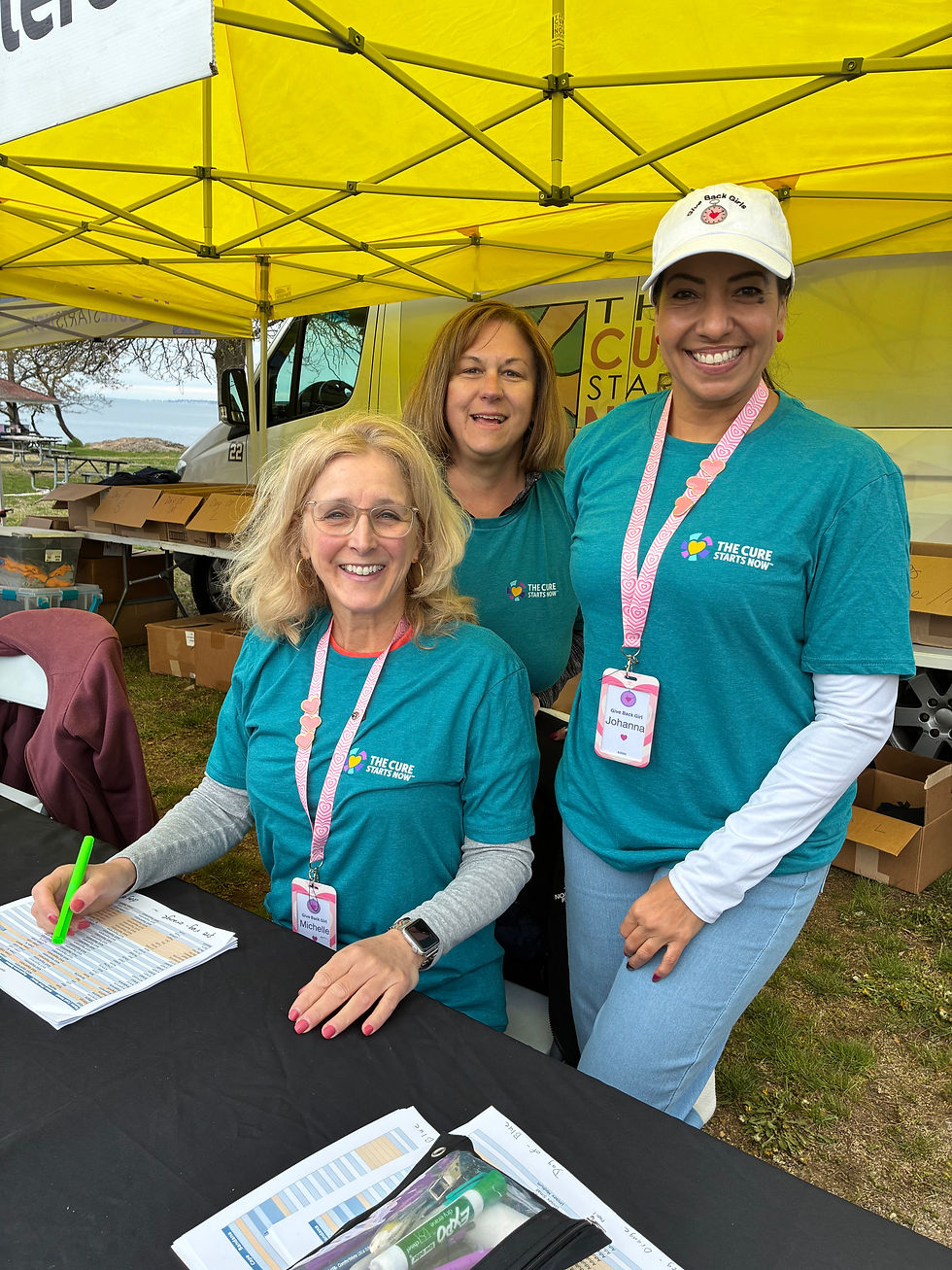 Give back girls michelle, lori, and Johanna at the check in desk for the blast cancer walk for the cure starts now milford chapter