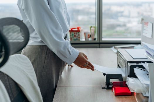 Business professional using a network printer supported by managed IT services for secure document printing and office productivity.
