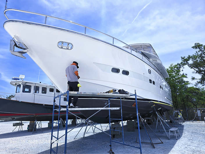 Barbers Marina. Buffing hull on yacht. Compound polish wax