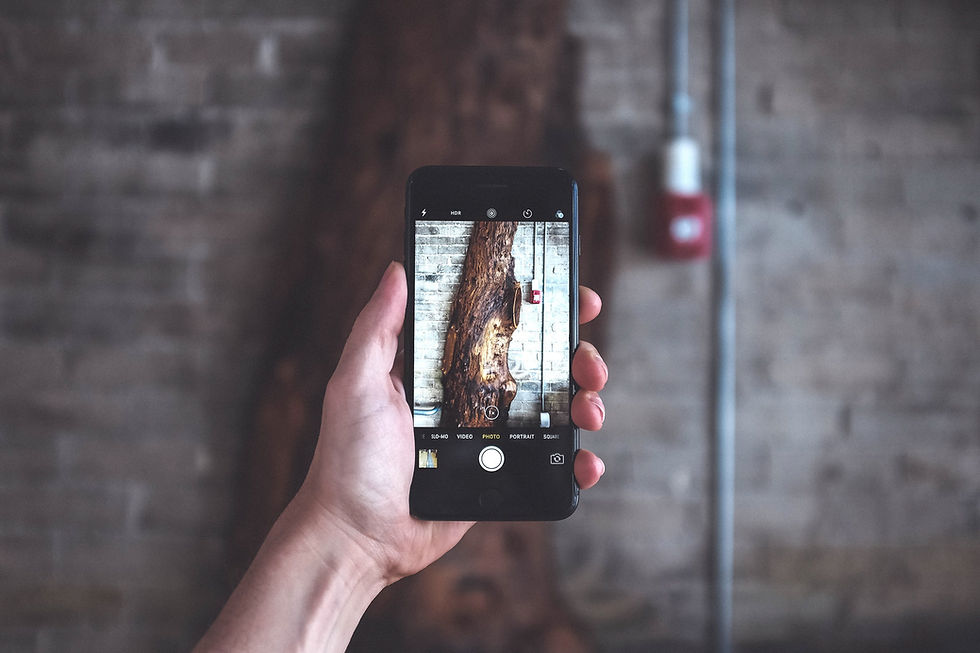 Hand holding a smartphone to take a photo