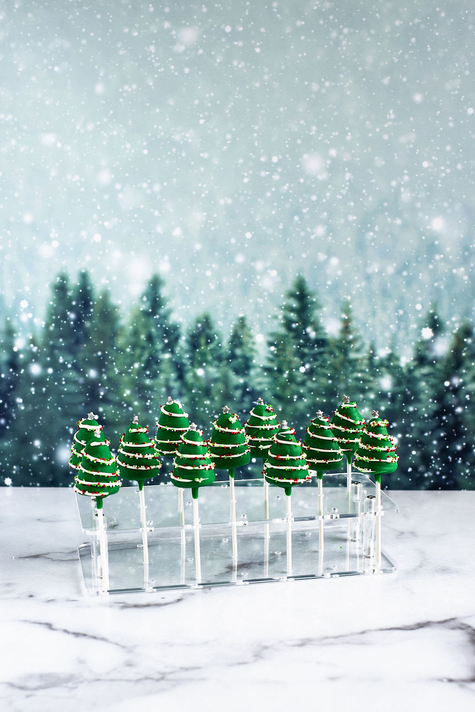 Christmas Tree-shaped cake pops made from vanilla cake and coated in white chocolate.
