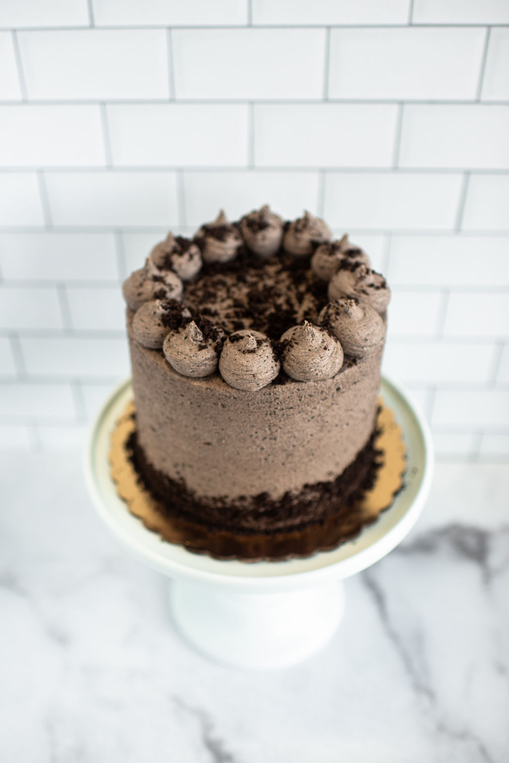 Decadent chocolate cake with Oreo cookies in cream buttercream frosting