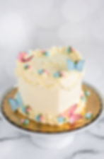 Thumbnail: Vintage style lambeth heart cake with butterfly design and gender reveal filling