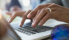 Man Typing on a Laptop