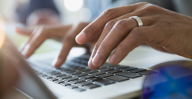 Man Typing on a Laptop
