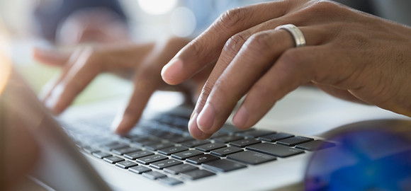 Man Typing on a Laptop