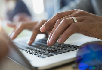 Man Typing on a Laptop