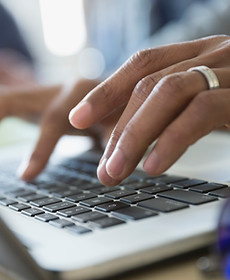 Man Typing on a Laptop