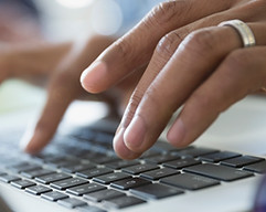 Man Typing on a Laptop
