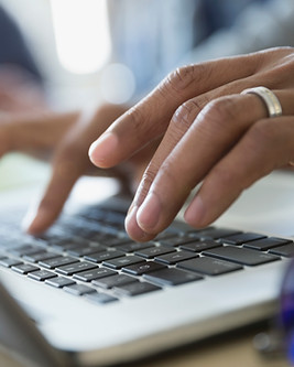 Man Typing on a Laptop