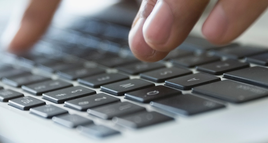 Man Typing on a Laptop