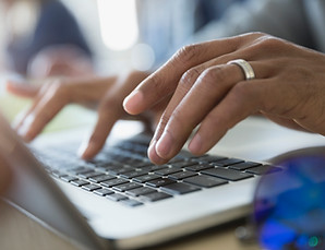 Auhor typing on a laptop