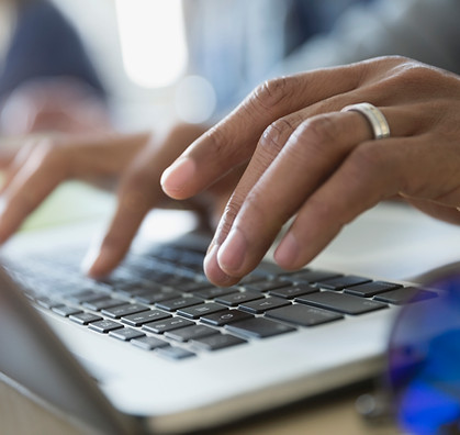 Man Typing on a Laptop