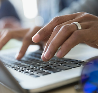 Man Typing on a Laptop