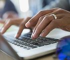 Man Typing on a Laptop