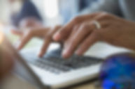 Man Typing on a Laptop