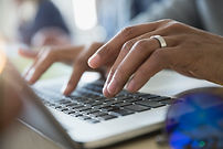 Man Typing on a Laptop
