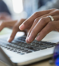 Man Typing on a Laptop