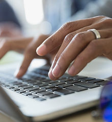 Man Typing on a Laptop
