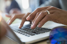 Man Typing on a Laptop