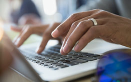 Man Typing on a Laptop