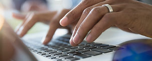 Man Typing on a Laptop