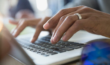 Man Typing on a Laptop