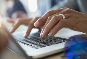 Man Typing on a Laptop