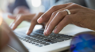 Man Typing on a Laptop