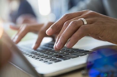Man Typing on a Laptop