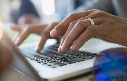 Man Typing on a Laptop
