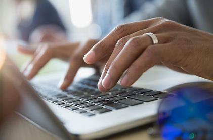 Man Typing on a Laptop