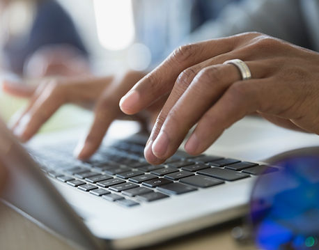 Man Typing on a Laptop