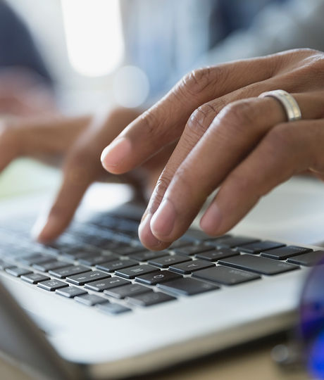 Man Typing on a Laptop