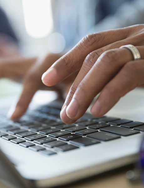 Man Typing on a Laptop