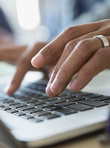 Man Typing on a Laptop