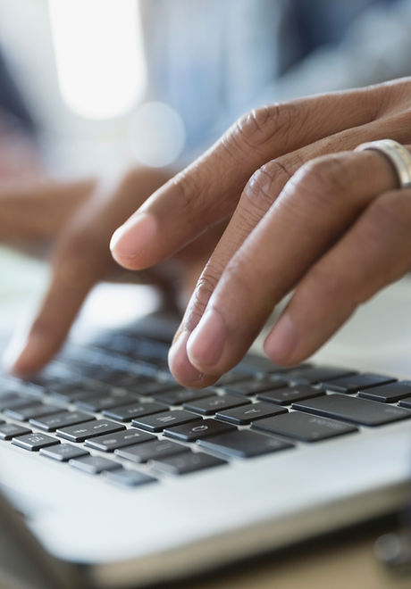 Man Typing on a Laptop