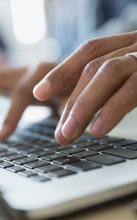 Man Typing on a Laptop