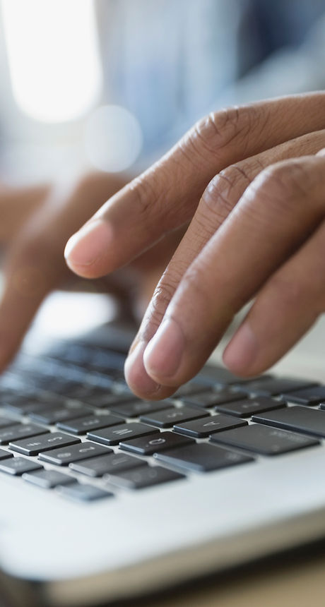 Man Typing on a Laptop